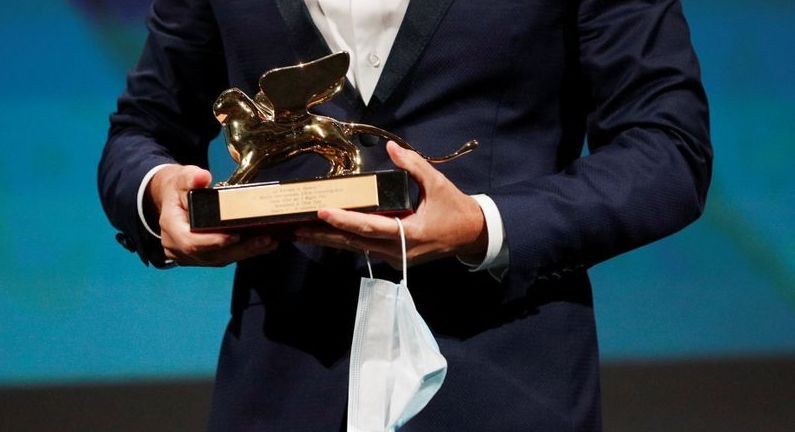 The 77th Venice Film Festival - Awards Ceremony - Venice, Italy, September 12, 2020 - Head of Marketing of Disney Italy, Davide Romani receives the Golden Lion award on behalf of director Chloe Zhao for Best Film "Nomadland". (Reuters Photo)
